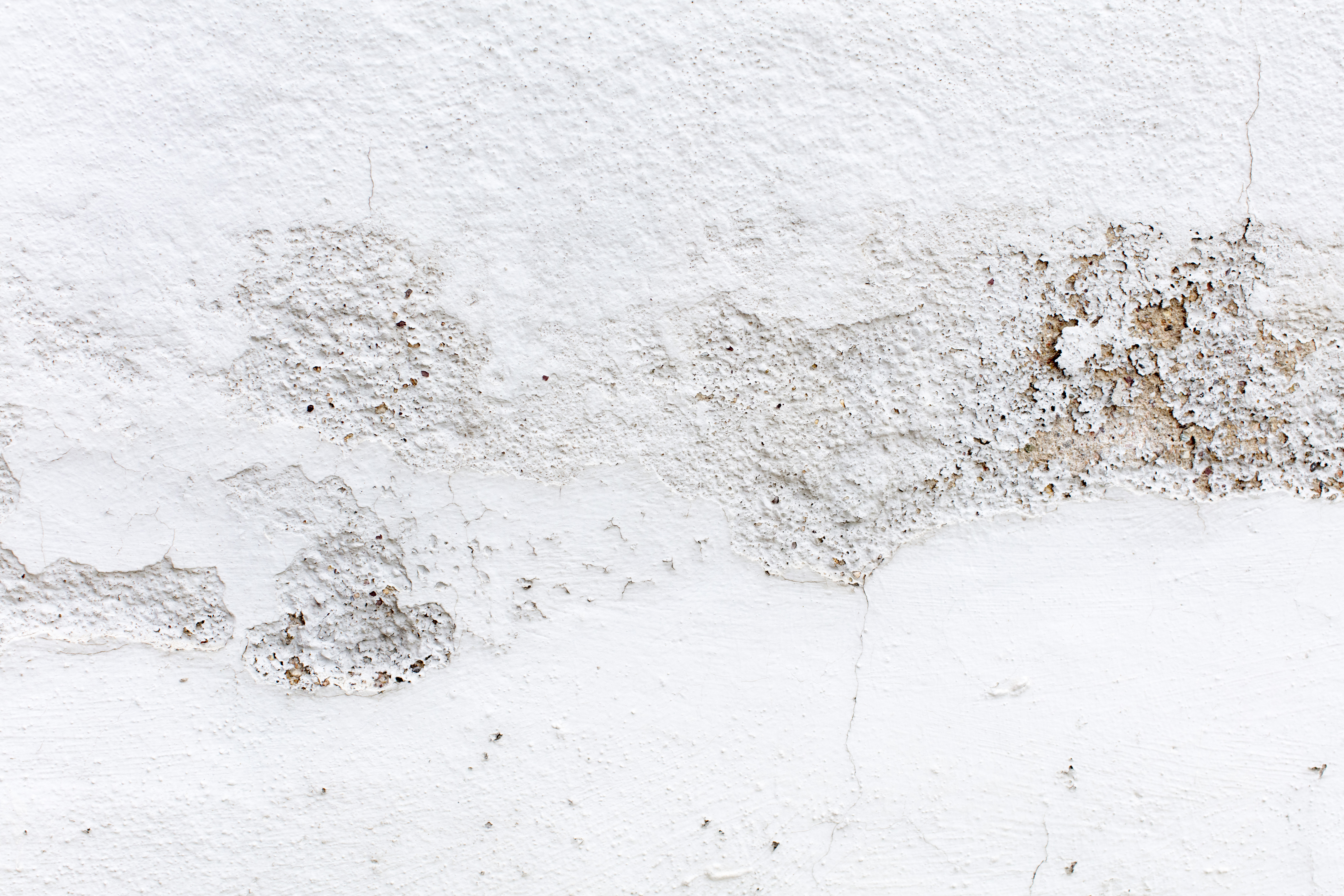 Corner of an interior wall showing damp stains and mould growth caused by moisture buildup in a new build property.