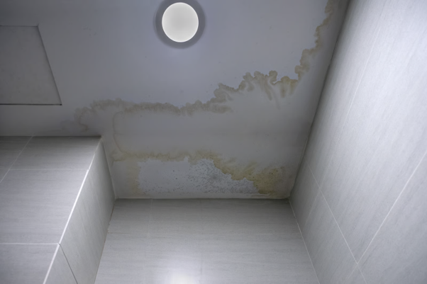 Water staining and moisture damage on a ceiling requiring commercial water damage restoration investigation.